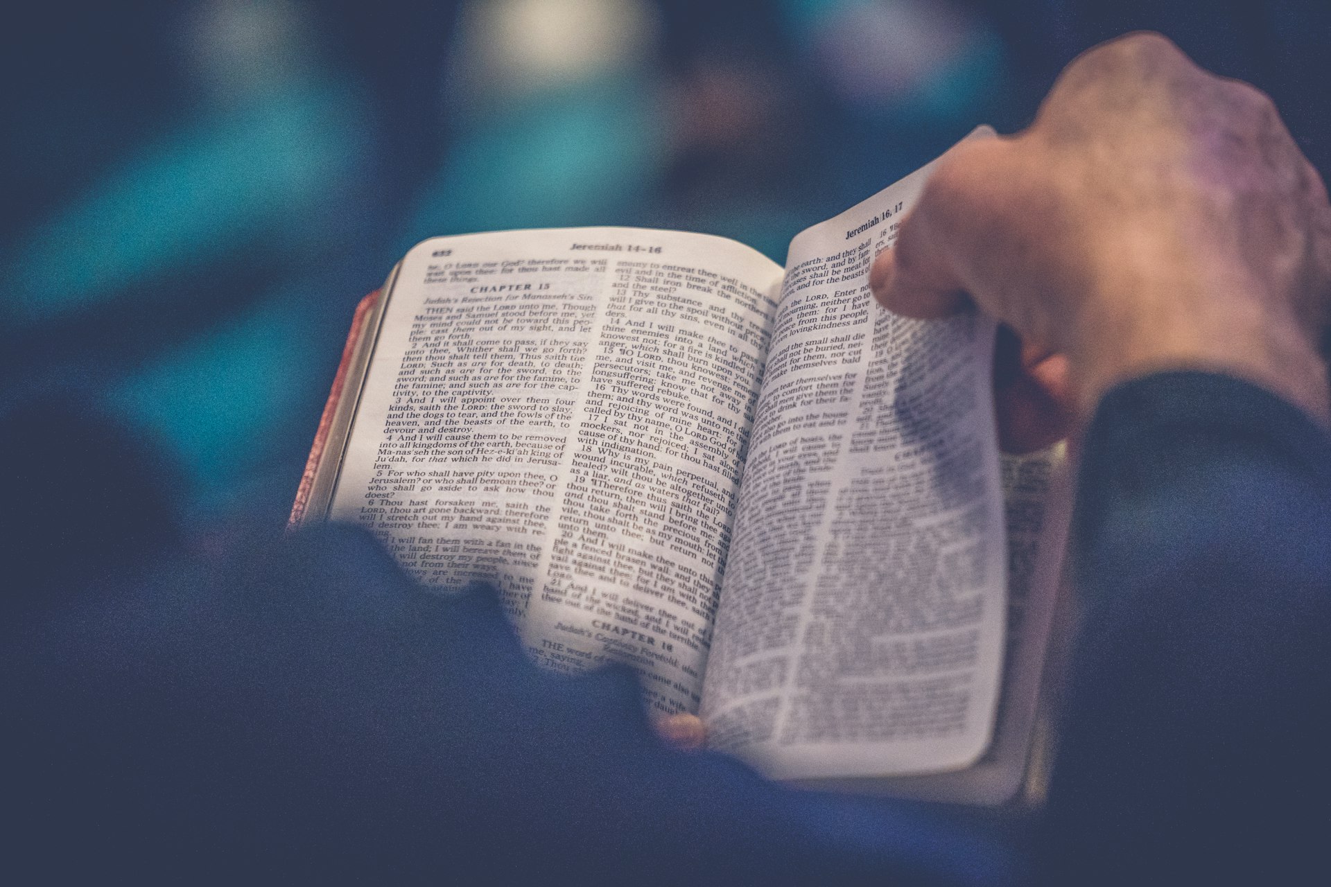 Open Bible held in two hands, open to the book of Jeremiah